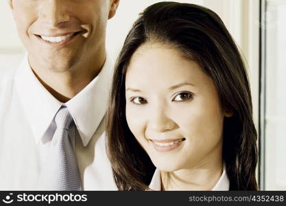 Portrait of a businesswoman and a businessman smiling