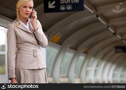 portrait of a businesswoman at train station