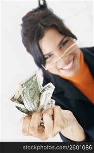 Portrait of a businesswoman crushing American dollar bills