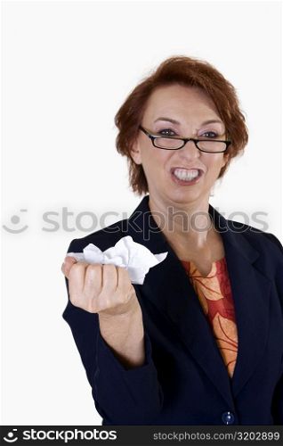 Portrait of a businesswoman crushing paper