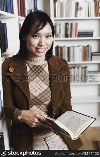 Portrait of a businesswoman holding a book smiling
