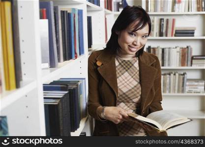 Portrait of a businesswoman holding a book smiling