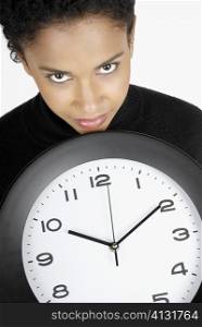 Portrait of a businesswoman holding a clock