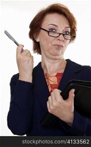 Portrait of a businesswoman holding a file and a pen