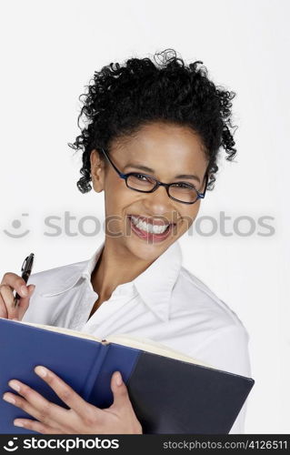 Portrait of a businesswoman holding a file with a pen