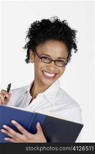 Portrait of a businesswoman holding a file with a pen