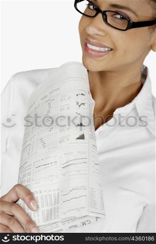 Portrait of a businesswoman holding a financial newspaper and smiling