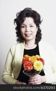 Portrait of a businesswoman holding a flower vase