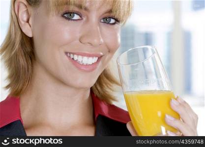 Portrait of a businesswoman holding a glass of juice