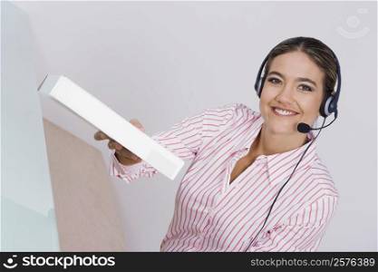 Portrait of a businesswoman holding a package and smiling