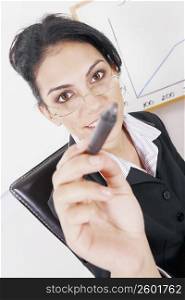 Portrait of a businesswoman holding a pen and smiling