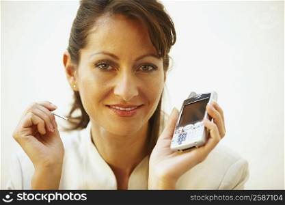 Portrait of a businesswoman holding a personal data assistant