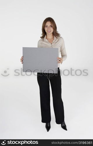Portrait of a businesswoman holding a placard and smiling