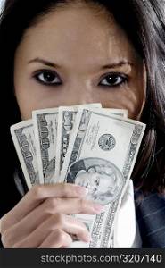 Portrait of a businesswoman holding American dollar bills