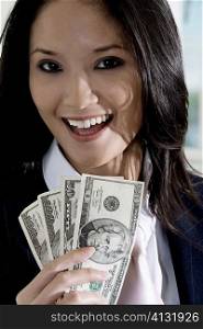 Portrait of a businesswoman holding American dollar bills