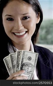 Portrait of a businesswoman holding American paper currency