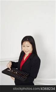 Portrait of a businesswoman holding an abacus and smiling