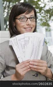 Portrait of a businesswoman holding bills and smiling