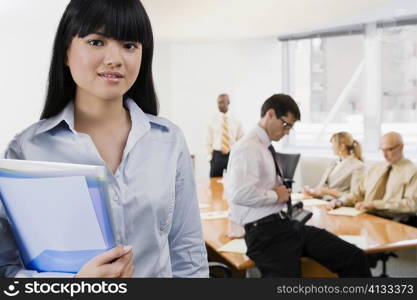 Portrait of a businesswoman holding files