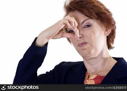 Portrait of a businesswoman holding her nose