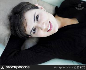 Portrait of a businesswoman lying with her hand behind her head
