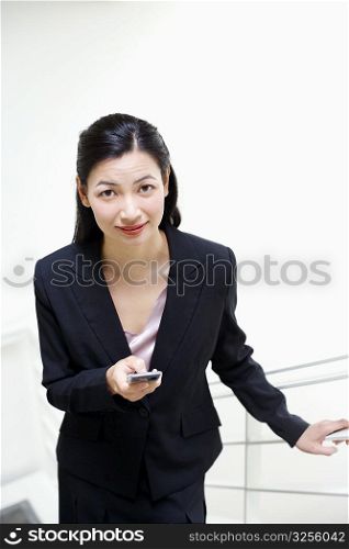 Portrait of a businesswoman operating a mobile phone