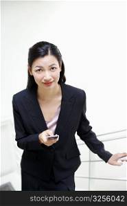 Portrait of a businesswoman operating a mobile phone