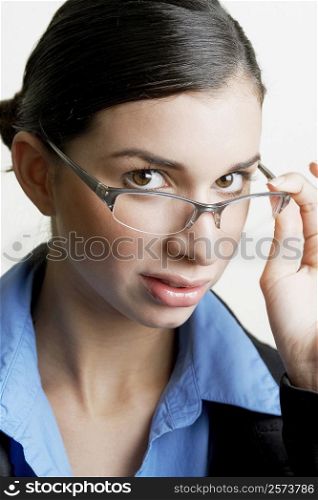 Portrait of a businesswoman peeking over her eyeglasses