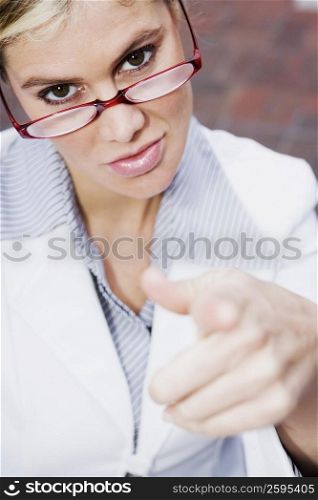 Portrait of a businesswoman pointing forward