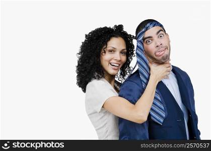 Portrait of a businesswoman pretending to strangulate a businessman