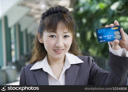 Portrait of a businesswoman showing a credit card