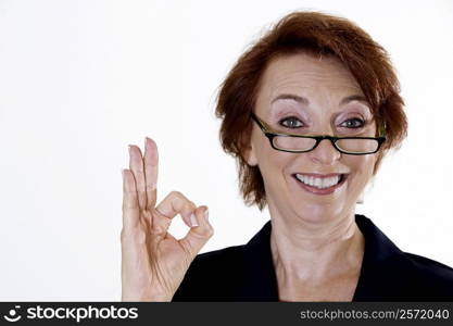 Portrait of a businesswoman showing an ok sign