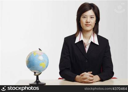 Portrait of a businesswoman sitting at a table in an office