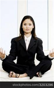Portrait of a businesswoman sitting in the lotus position