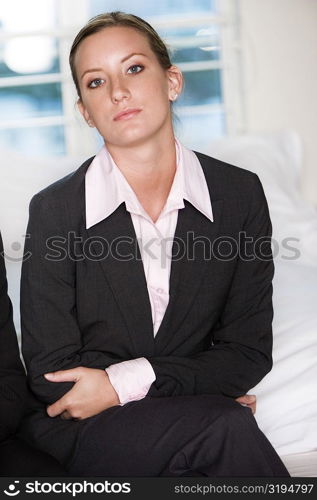 Portrait of a businesswoman sitting on a bed