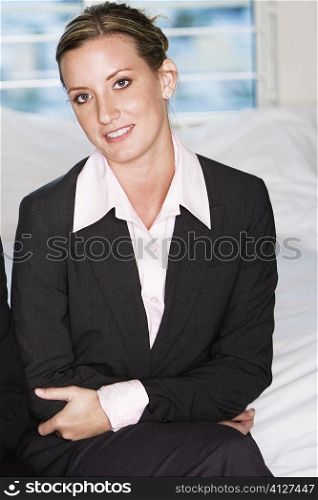 Portrait of a businesswoman sitting on a bed