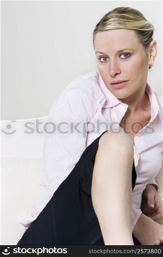 Portrait of a businesswoman sitting on the bed