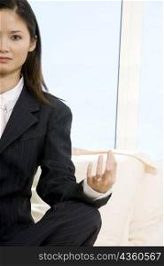 Portrait of a businesswoman sitting with her legs crossed