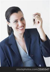 Portrait of a businesswoman smiling and holding keys