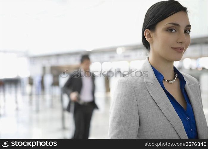 Portrait of a businesswoman smiling at an airport lounge