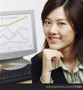 Portrait of a businesswoman smiling with a progress report in the background