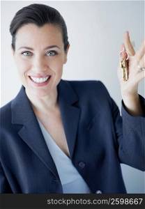 Portrait of a businesswoman smiling with holding keys