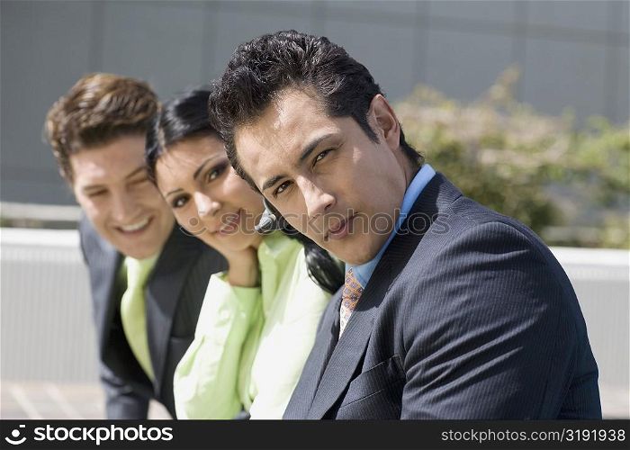 Portrait of a businesswoman smiling with two businessmen