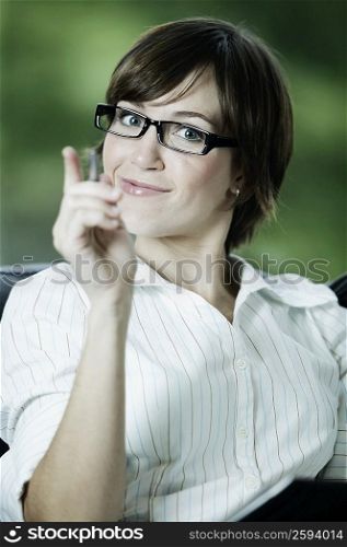 Portrait of a businesswoman smirking and pointing forward