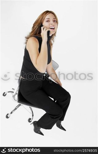 Portrait of a businesswoman talking on a mobile phone and laughing