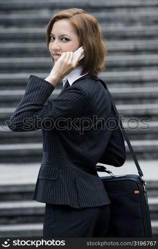 Portrait of a businesswoman talking on a mobile phone and smiling