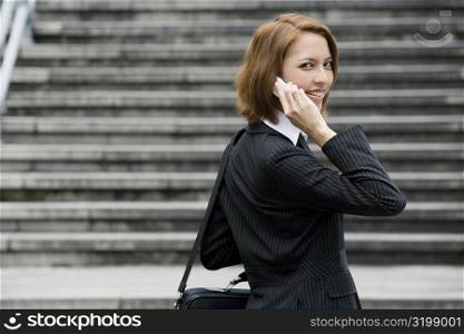 Portrait of a businesswoman talking on a mobile phone and smiling