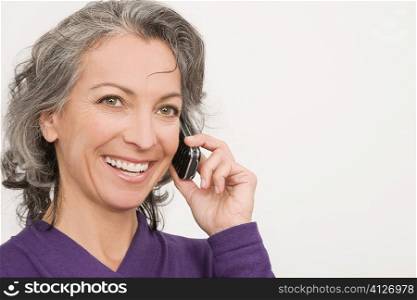 Portrait of a businesswoman talking on a mobile phone and smiling