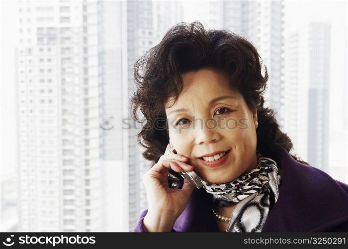 Portrait of a businesswoman talking on a mobile phone smiling