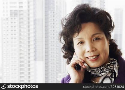 Portrait of a businesswoman talking on a mobile phone smiling